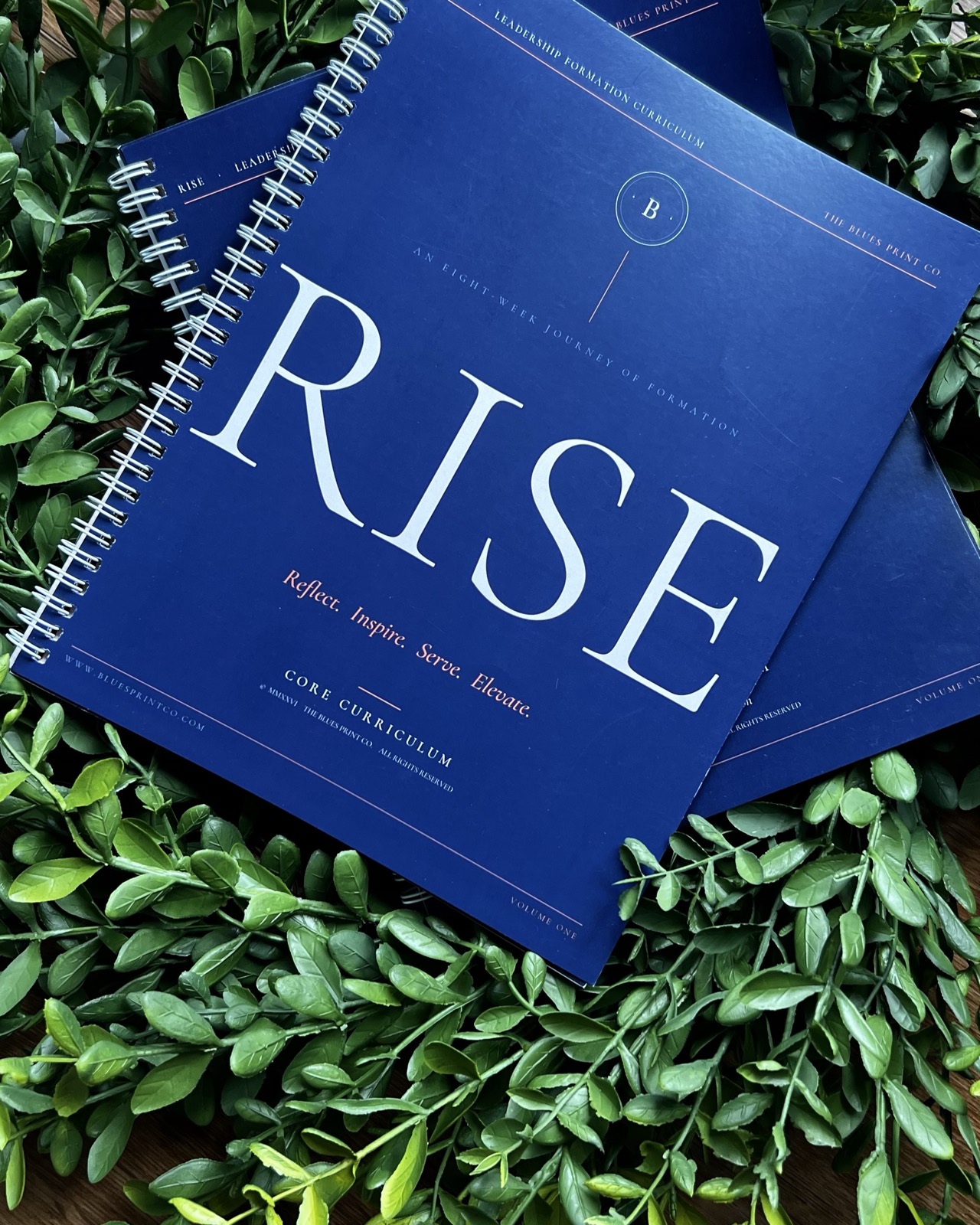 The Core curriculum guides in navy, styled on greenery